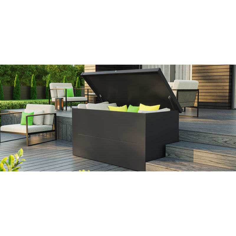 A Telluria Nevio storage box on a decked terrace with the lid open and seat cushions stacked inside, garden furniture alongside