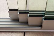 The floor track supplied with the Telluria sliding doors, set flush into the paving with the glass panels seated in it, so there is no step to trip over across the opening