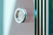 Round stainless steel handle fitted through a Telluria sliding door panel, one of the parts included in the sliding door price