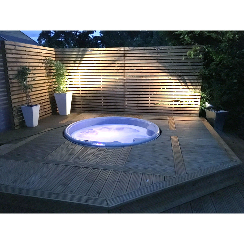 RotoSpa Orbis Round hot tub in a garden setting