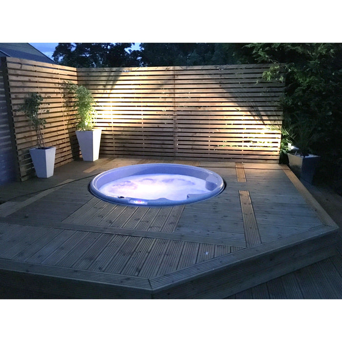 RotoSpa Orbis Round hot tub in a garden setting