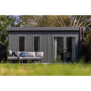 Telluria Luminato 5436 Plus garden room framed by lawn and mature trees, the double doors open onto a paved terrace with seating