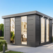 Anthracite Telluria Luminato 3030 steel garden room used as a home office, lit inside, on a paved base beside a house